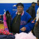 A woman looks through clothing at Saturday's Threads for the City Clothing Drive & Swap.