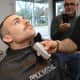 Hillsdale Officer Corey Rooney, the newest member of the force, losing his beard.