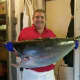 Manager Scott Bennett holds up a fresh tuna.
