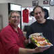 Rowayton Seafood manager Scott Bennett hands over a shrimp platter to a happy customer on Christmas Eve.