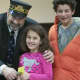 Dennis the Train Man punches a ticket for a child at the Westport Library Thursday.