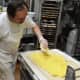 Baker Bill Sidlovsky of West Milford, who started baking in his teens, applies a butter blend as he works on laminating Danish dough.