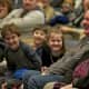 A family watches a show at Saugatuck Elementary.