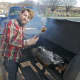 Shelton's Whitehill Smoke Eaters prepares brisket in a smoker outside of Saturday's indoor farmers market.