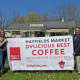 Daily Voice Director of Media Initiatives/Managing Editor Joe Lombardi presents Hayfields Market's Renyea Dayton with DVLicious roadside banner.