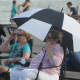 Many brought umbrellas to try to beat the heat on a 95-degree afternoon in Cold Spring.