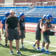 Coach Jim Donahoe works with the Rams at a recent practice.
