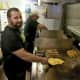 At the grill: Omelettes, bacon and home fries are some of the most popular items at Eggs and Company.