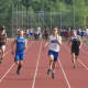 Sprinters race toward the finish in the 100.