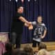Fourth grader Michael Amato is amazed by Danny Magic's animal cracker trick.