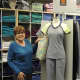Diane Some with a scrub uniform from her huge inventory of comfortable, wearable work clothes.