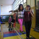 Dows Lane Elementary School second-grader, who is studying about balance and motion in her science class, learned how to walk on a tightwire during a visit by the Amazing Grace Circus.