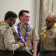 Scoutmaster Bill Severino bestows on John Mullins the Eagle Scout neckerchief as troop co-leader Mike Toscano looks on.