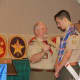 Troop 17 assistant scoutmasters present Victori with the Eagle Badge and Neckerchief.
