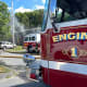 Firefighters at the scene of a three-alarm fire at 2 Manor Drive, Groveland, on Friday afternoon.