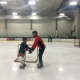 Volunteer Justin Italiano of Rutherford helps a member of the NJ Avalanche learn to balance and skate.