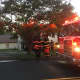 Danbury firefighters work at the scene of a two-alarm blaze at 43 Stadley Rough Road on Tuesday evening.