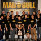 Coaches for the Norwalk Mad Bulls show the championship trophy.