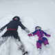 A mother and her toddler enjoy making snow angels in Poughkeepsie.