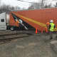 Officials on the scene of a truck stuck on the tacks near the West Redding train station.