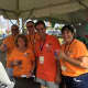 Volunteers at the Oyster Festival Saturday pose for a picture at the ticket booth for the craft beer tent. 