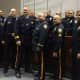 Members of the Little Falls Police Department come together during a swearing-in ceremony for the new chief and lieutenant Monday, Dec. 7.