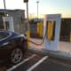 A Tesla recharges at the Darien I-95 South rest area Monday afternoon. The state's recently rebuilt service plazas offer charging stations for electric vehicles. 