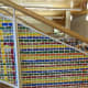 Artist Katherine Daniels created an art installation of colorful plastic strips woven into the gridded surround of Greenwich Library's grand stairs.