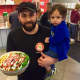 Jaffar Wahdat with son, Ali, in Juicy Platters Hackensack. He is holding grilled chicken over sautéed greens: Green Blast® is sautéed Kale, Broccoli, Spinach & Cilantro in Extra Virgin Olive Oil.