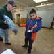 District Deputy of the Connecticut State Knights of Columbus George Ribellino helps Lazandro Jaurez, 10, find a new coat during the Knights of Columbus Coats for Kids program Friday, Nov. 24, at St. Joseph Church in South Norwalk.