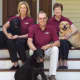 Jennifer Hill (left), president and CEO of Canine Company, with her parents, Henry and Carol Hill, who founded the company 30 years ago, along with a few of the family's pets.
