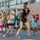 Jill Liflander, who also did a puppet show at the event, led kids in a slow-motion Olympic run, set to "Chariots of Fire."