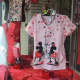 Character scrubs are always popular! Mickey and Minnie kiss in the Valentine's Day window.