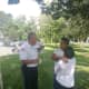 A member of Ramapo PD talks with two community members during the Recruitment Outreach event on Wednesday.