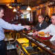 Sapore Steakhouse's general manager pours a little vino for two of the chefs at the Fishkill eatery.