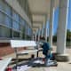 A student paints a bench to show school spirit at Saxe Middle School.
