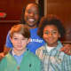 New Canaan Country School sixth graders Byrne Matthews, left, of Norwalk and Mason Pratt of Trumbull with guest speaker, author, rapper and university professor, Dr. Omékongo Dibinga, at an assembly honoring Martin Luther King Jr.