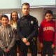 Greenwich Police Officer Ryan Beattie with Western Middle School Grade 8 students VictorColin, at left, and Derek Silva, at right, and Grade 7 and 8 Science teacher Tyler Mecozzi.