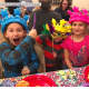 Kids in costumes celebrating St. James Church's Mardi Gras