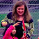 Mayor Diane Didio helps a young Oradell resident cut the ribbon on Hoffman Field Saturday.