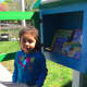 Alexa Cipriano, 4, grabs a book from the Little Library located at the entrance to the Norwalk Department of Health.