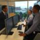 Gov. Dannel P. Malloy speaks with security operation center analysts Albert Straniti, center, and Jeriel Udom, right, at the official opening of CYBERshark in Stamford.
