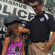 Gianna, 9, gets fitted for a police helmet at National Night Out in Paramus.