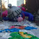 Super Grover slowly rises as it is inflated Saturday.
