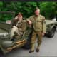 A pair of veterans on a vintage World War II vehicle.