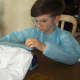 Mark Leschinsky ,9, of Mahwah, works on his prototype for the self-disinfecting suit last year.