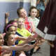 Elementary school students in Bethel extend hands to connect with high school seniors as they paraded through the halls on Thursday.