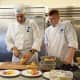 Chef Jeff Trombetta instructs a Norwalk Community College culinary arts student in proper food preparation.