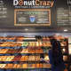 Nicole Smith reaches for a customer favorite at Donut Crazy in Shelton. 
