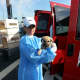 Volunteer Kristi Heller holds a dog rescued from a kill-shelter.